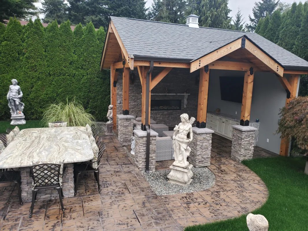 Covered timber-frame pavilion and stamped-concrete patio in the backyard