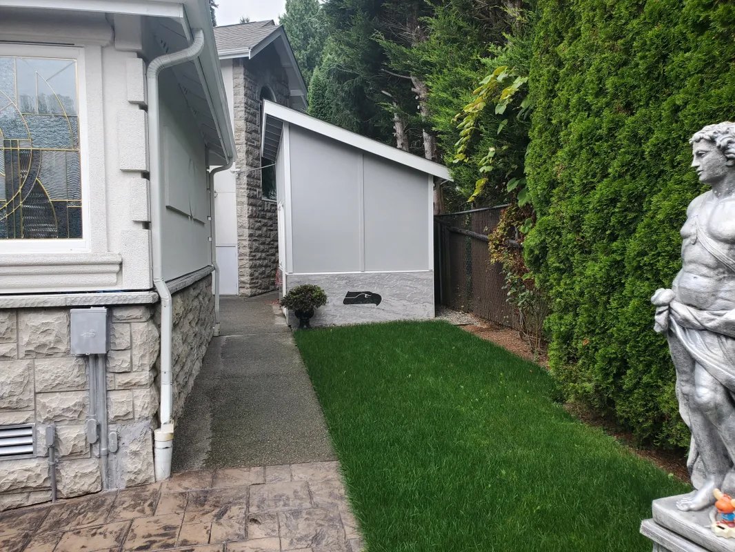 Side yard with lawn and garden statue